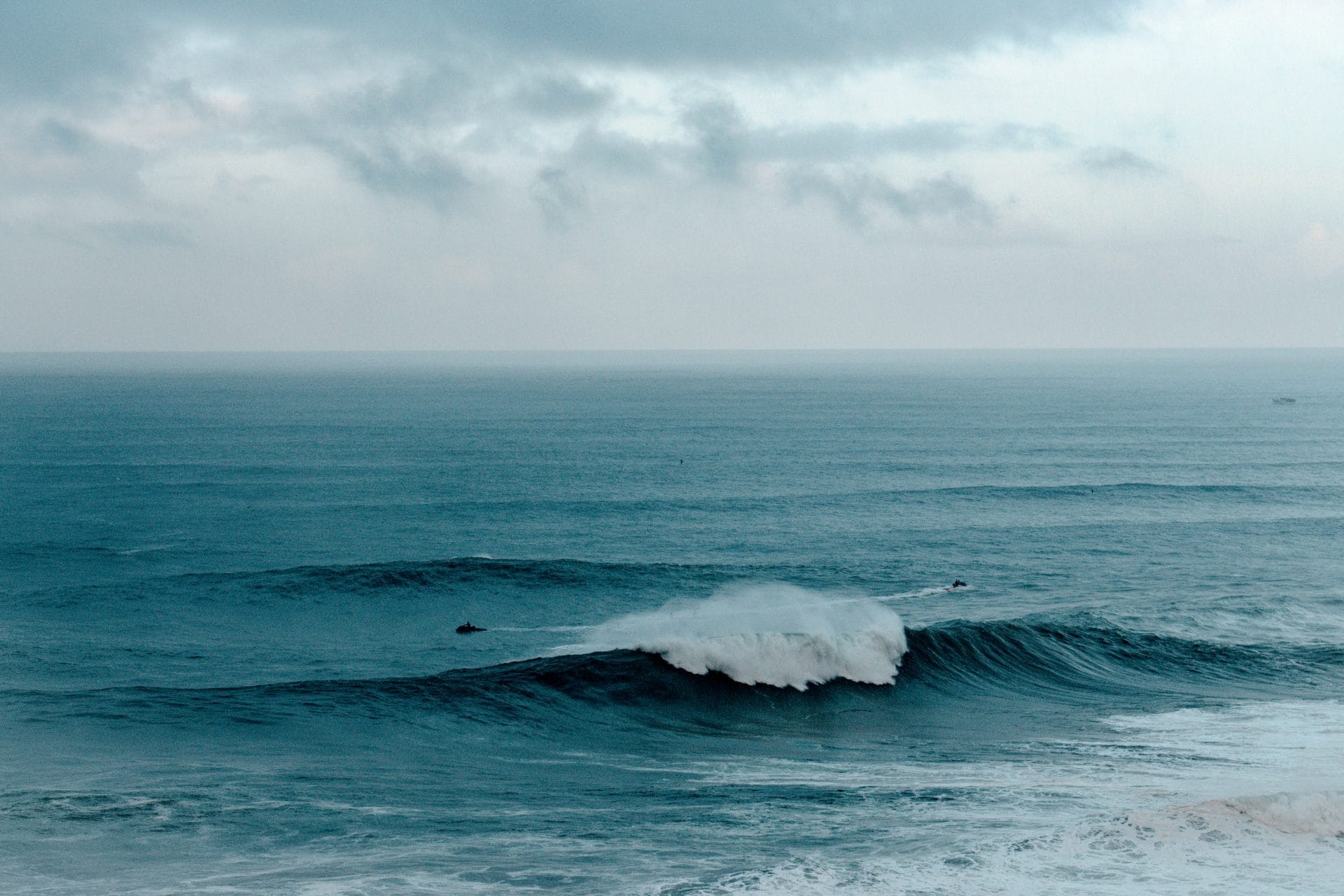 Big wave breaking at Praia do Norte in Nazaré with jet skis in the line-up, filmed during Galileo X-Plorer